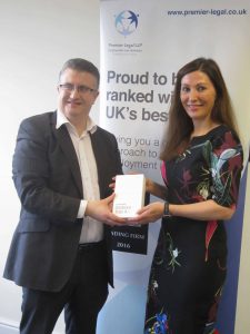 Sarah Robinson of Premier Legal receives a Galaxy Tab from Craig Pearson.