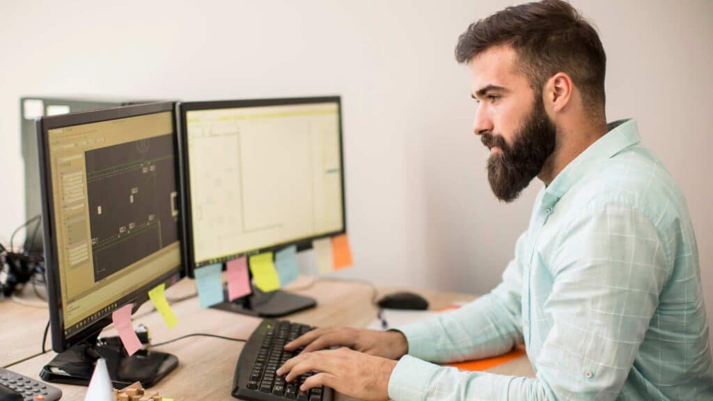 Man at desk working on his computer.